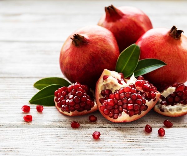 Ripe pomegranate fruits on  wooden vintage background